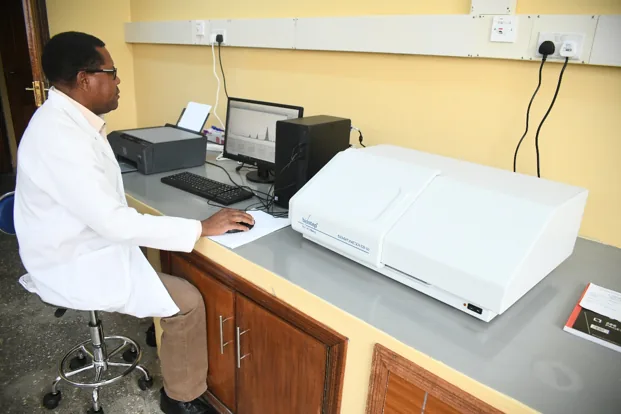 NPRC staff working on the High Performance Thin Layer Chromatography (HPTLC) Densitometer